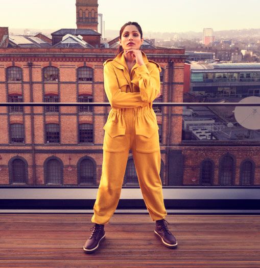 Freida Pinto posing in front of a building